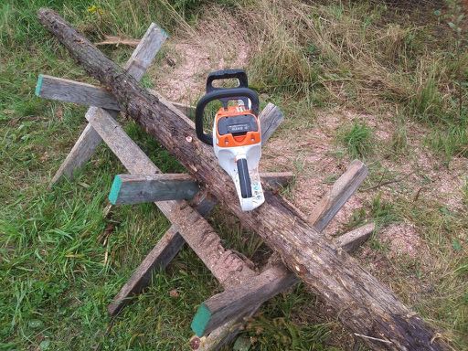 Image of MSA 200-C chainsaw from the rear, resting on sawbuck.