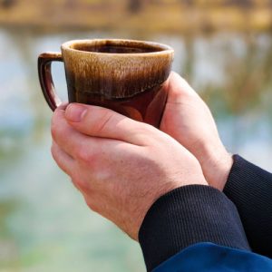 Image of hands cradling coffee cup