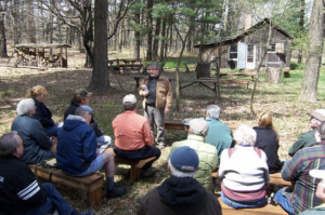 Image of tour group seated outside the Leopold shack.