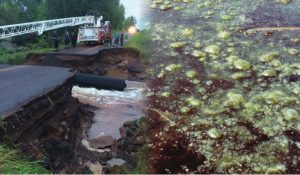 Image of fire truck extending its ladder over washed our section of roadway with new culvert laying the bottom.